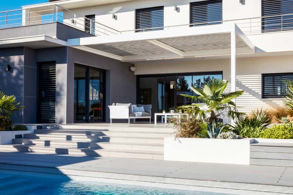 ADARTE bioclimatic pergola installed on a terrace with a pool